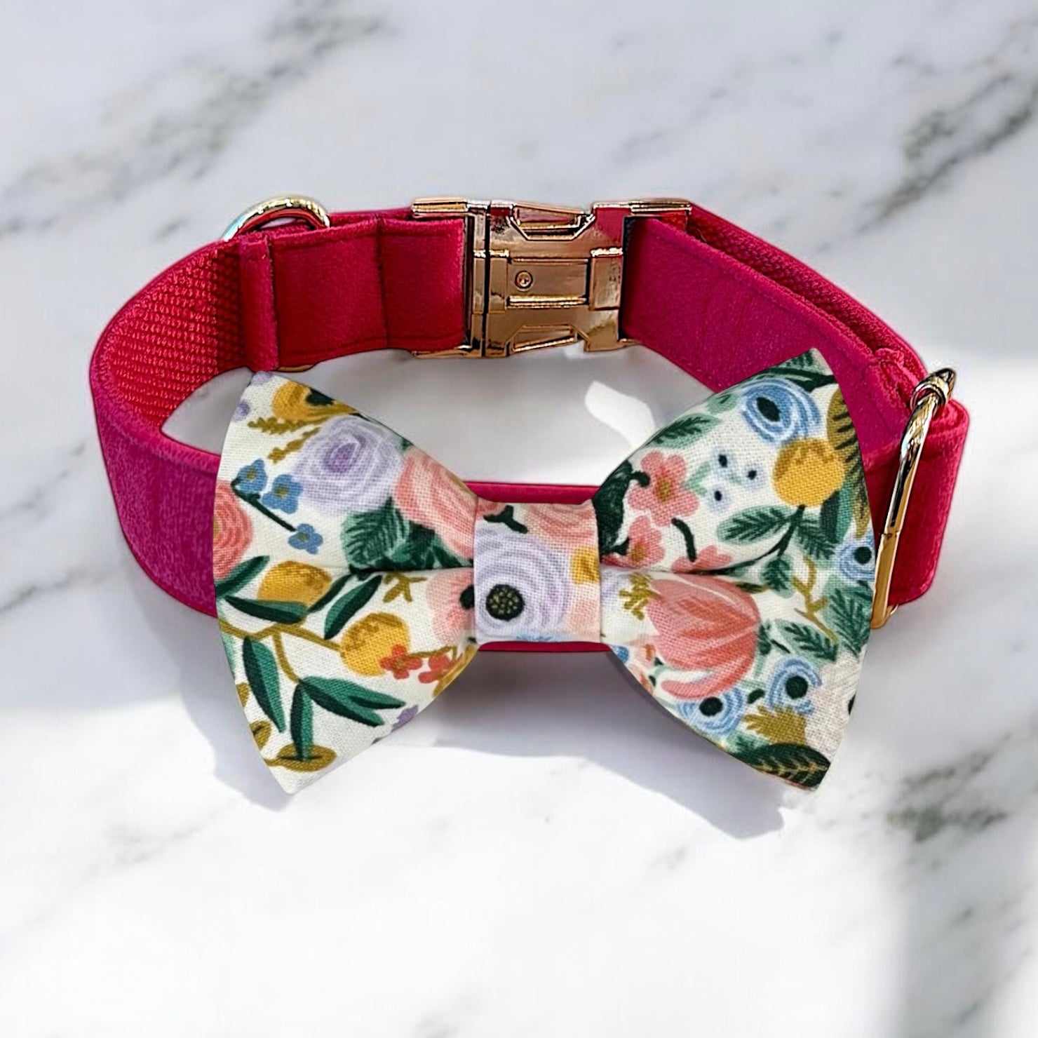 Dog collar with a floral bow tie on a marble background