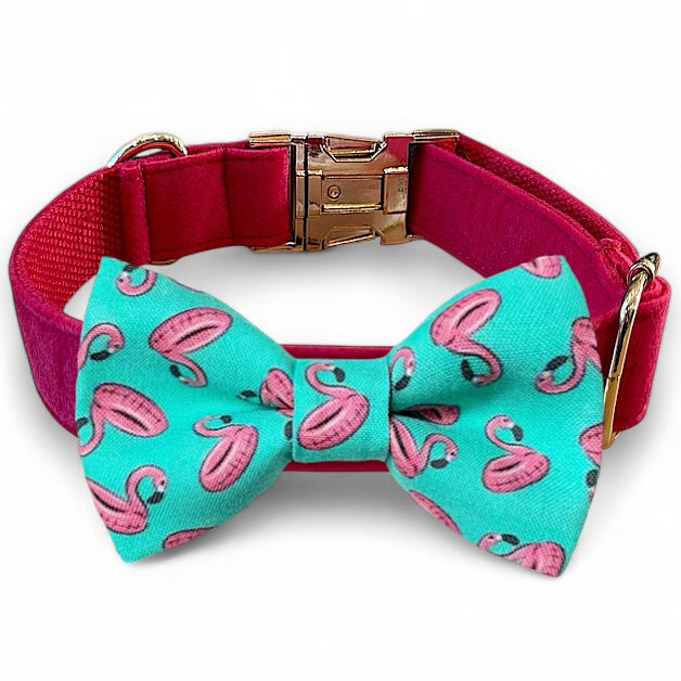 Dog collar with a turquoise bow tie featuring pink flamingo designs on a white background