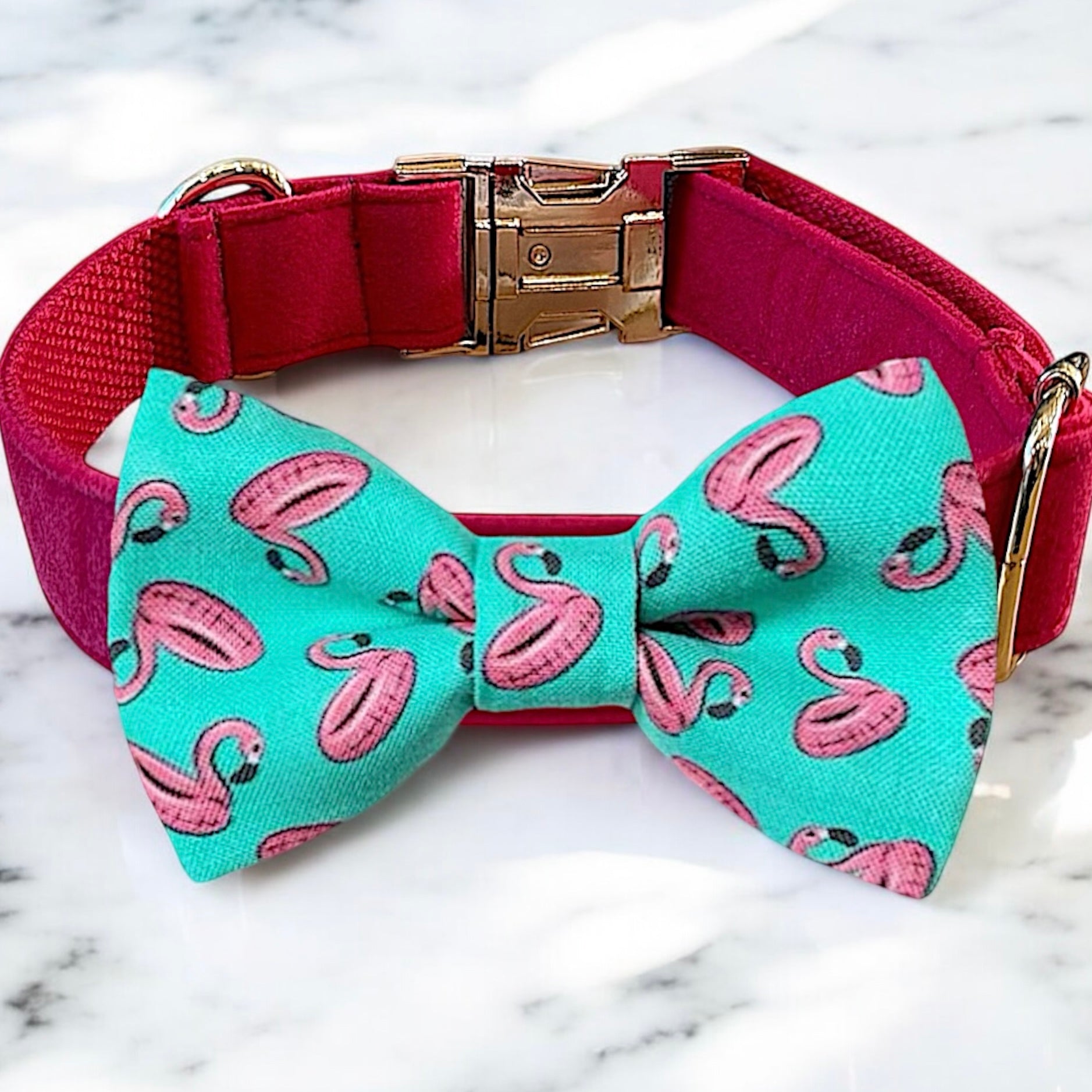 Dog collar with a flamingo pattern dog bow tie on a marble surface
