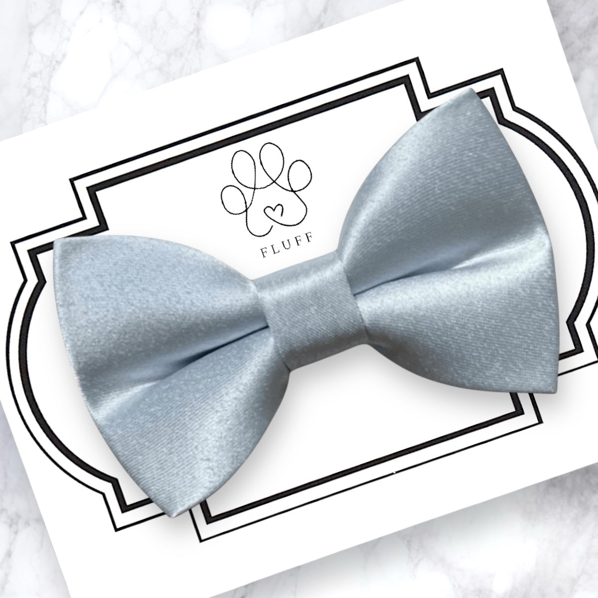 Cinderella blue dog bow tie on a decorative card with 'FLUFF' branding.