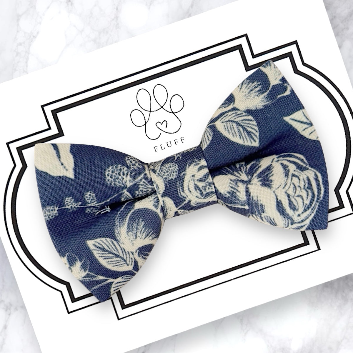Steel blue vintage floral bow tie on a white card with 'Fluff' branding