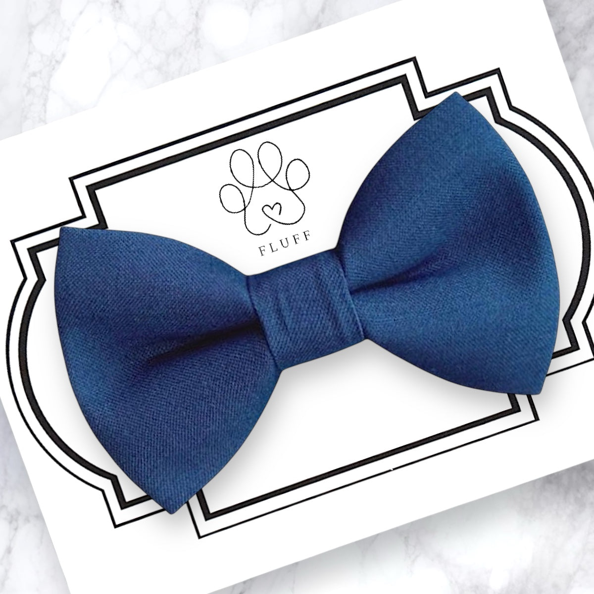 Steel blue bow tie on a white card with 'Fluff' branding