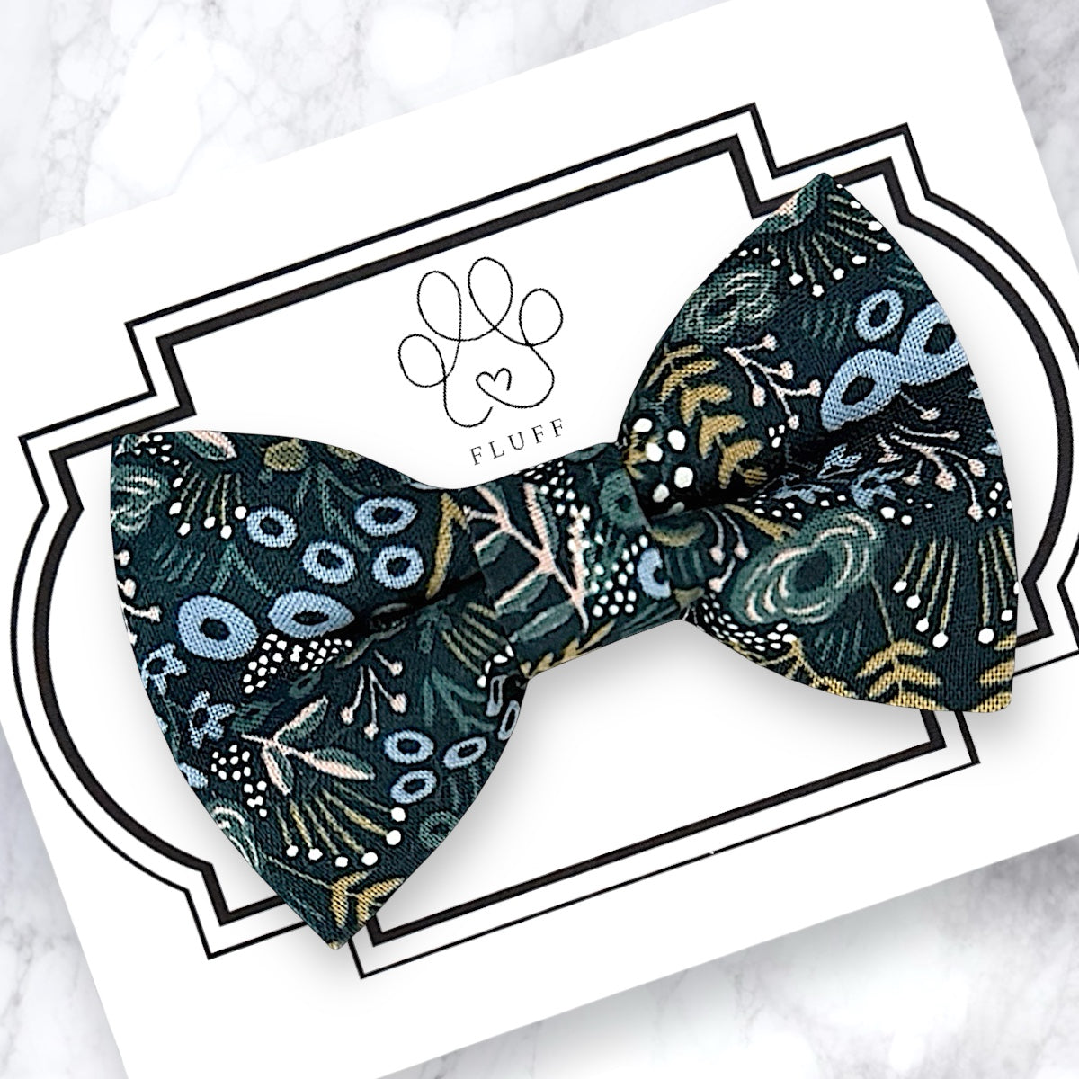Navy floral dog bow tie or cat bow tie on a branded card with a white background