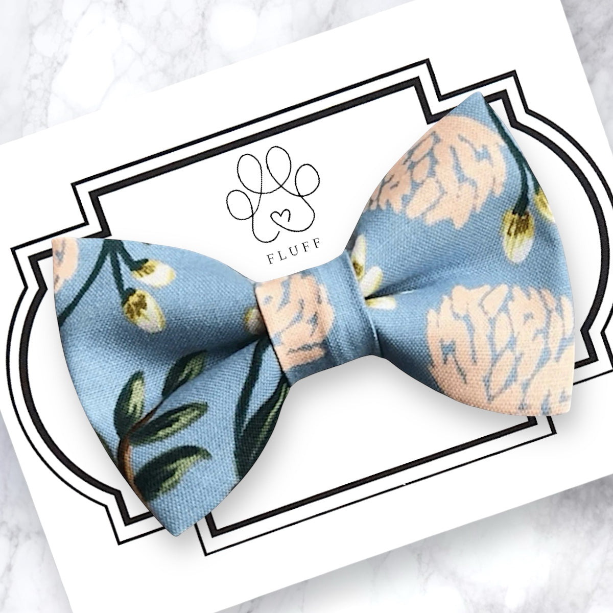 Hydrangea dog bow tie on a branded card with 'FLUFF' logo.