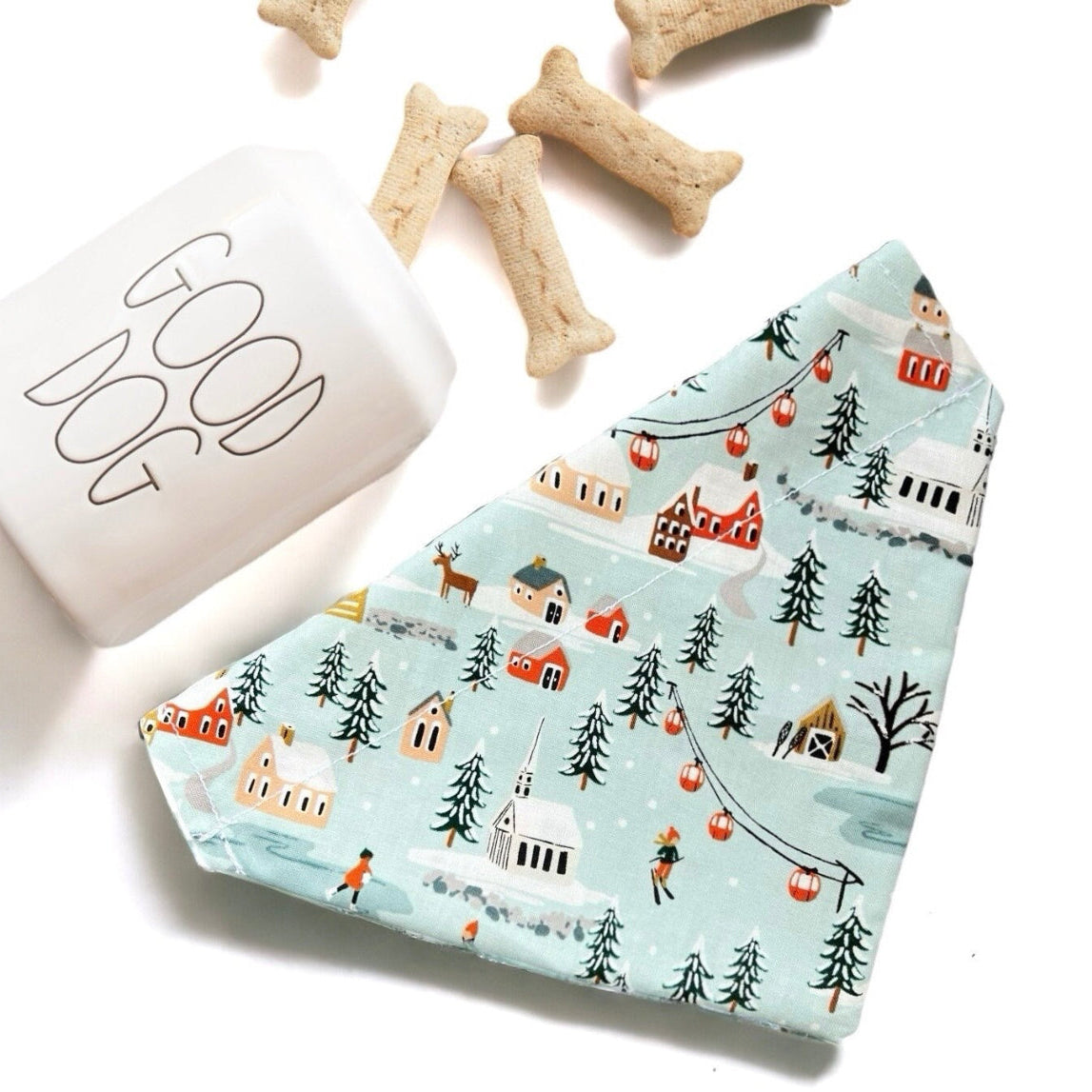 a dog bandana next to a dog bone and a dog treat