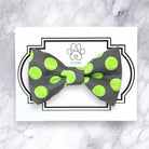 a gray and green bow tie with tennis balls on it