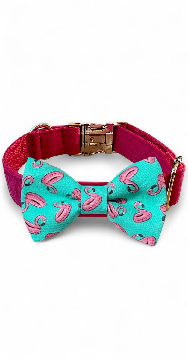 Dog collar with a turquoise bow tie featuring pink flamingo designs on a white background