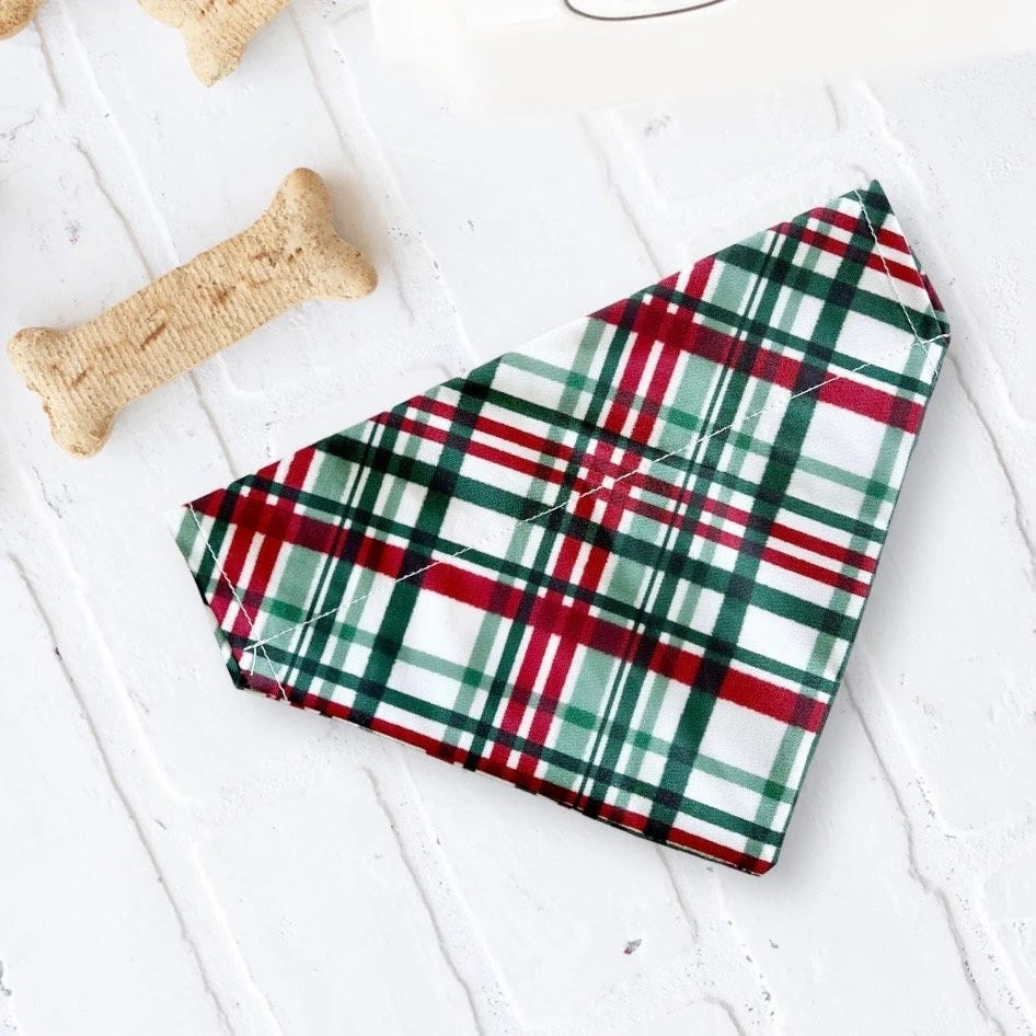 a plaid dog bandana laying next to a bone bone