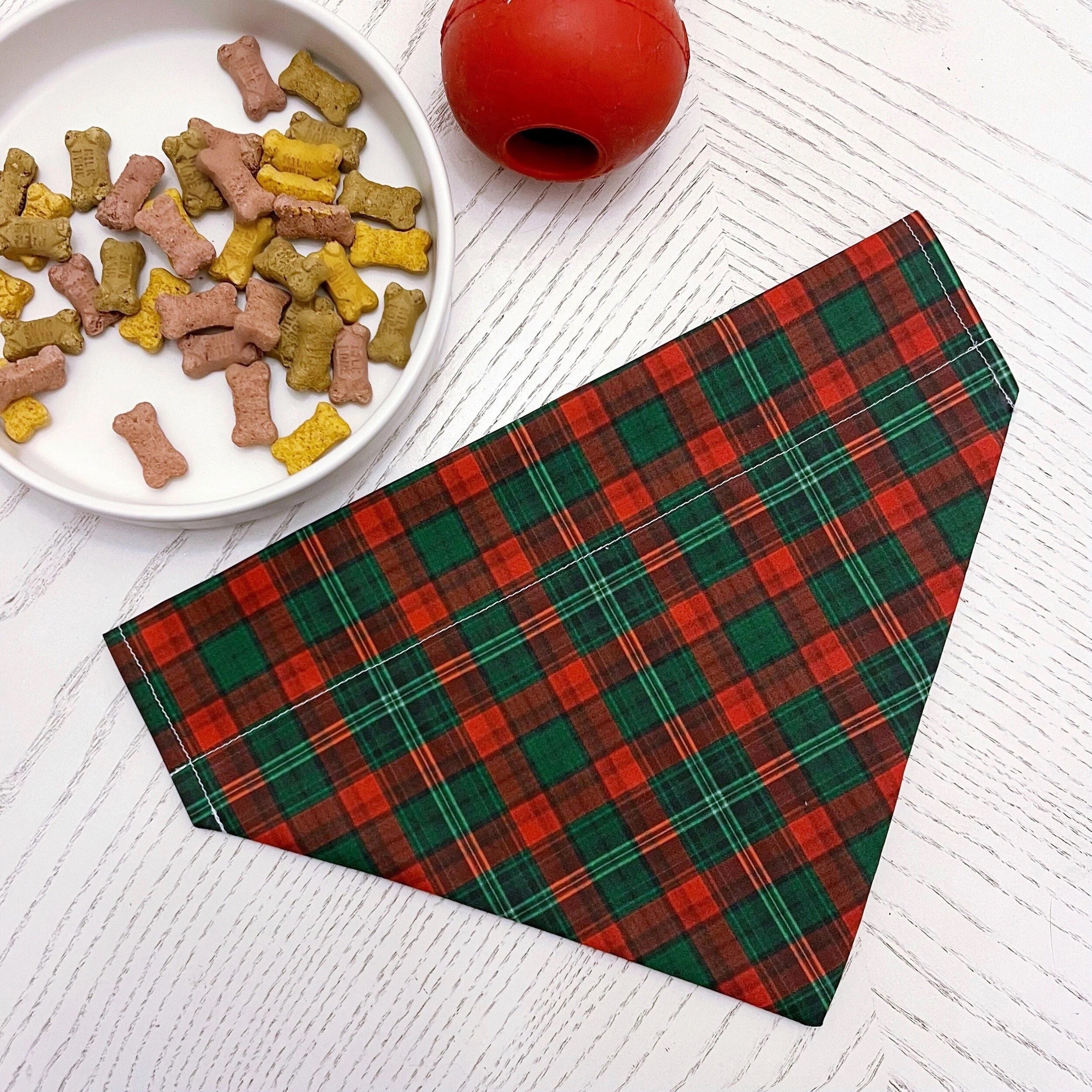 a bowl of dog food next to a plaid napkin