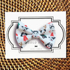 a white bow with black and red dogs on it