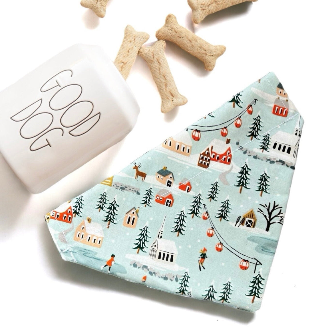 a dog bandana next to a dog bone and a dog treat