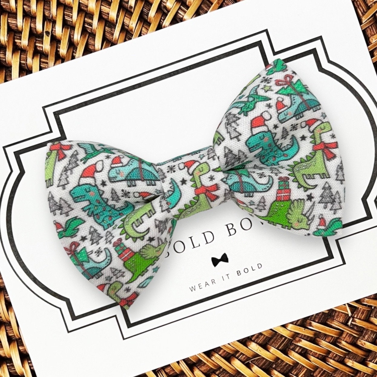 dinosaur Christmas dog bow tie on a white card.